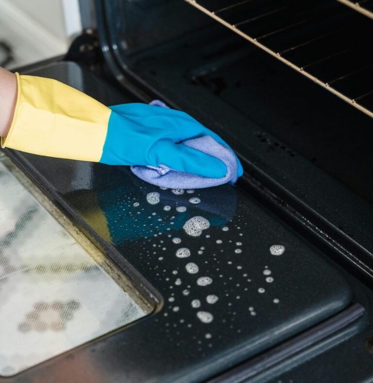 Cleaning an oven as part of deep cleaning services in Dallas